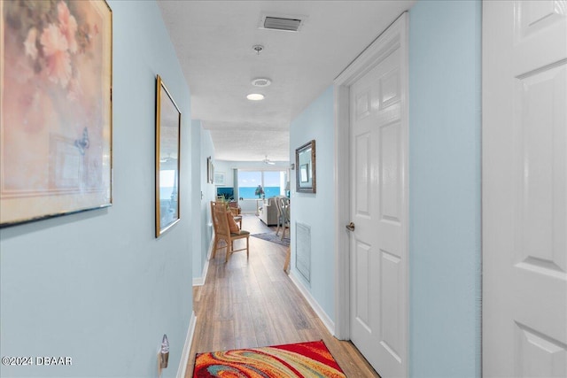 hall with light hardwood / wood-style floors