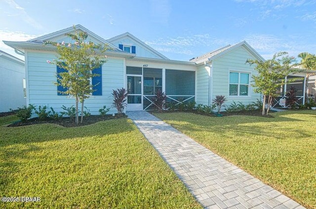 467 Salty Lime Pl, Daytona Beach, FL 32124 - view of front of property featuring a front yard and a sunroom