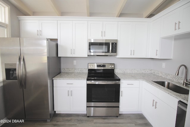 kitchen with sink, white cabinets, and appliances with stainless steel finishes