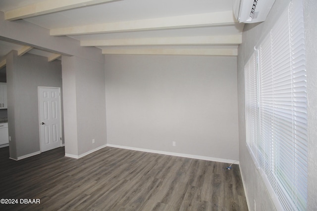 empty room with vaulted ceiling with beams, a wall mounted AC, and dark wood-type flooring