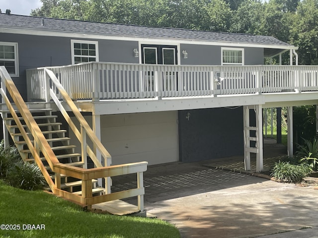 60 Bramblewood Ln, Ormond Beach, FL 32174 - back of property featuring roof with shingles, stairs, a wooden deck, a carport, and concrete driveway
