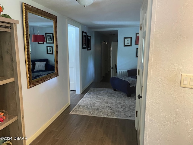 corridor with dark hardwood / wood-style floors