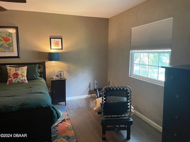 bedroom with dark hardwood / wood-style flooring