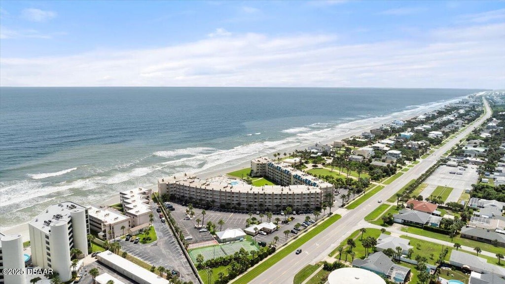 drone / aerial view featuring a beach view and a water view