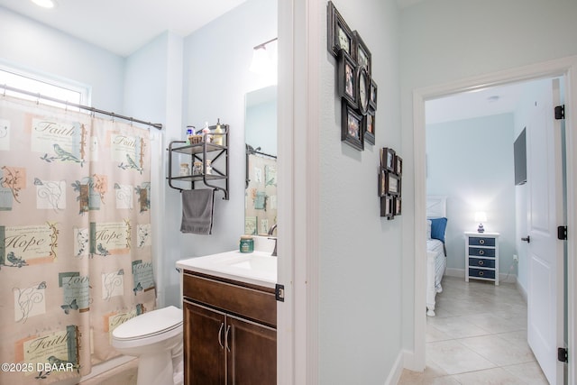 bathroom featuring toilet, vanity, and tile patterned floors