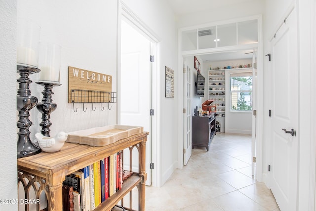 hallway with light tile patterned floors