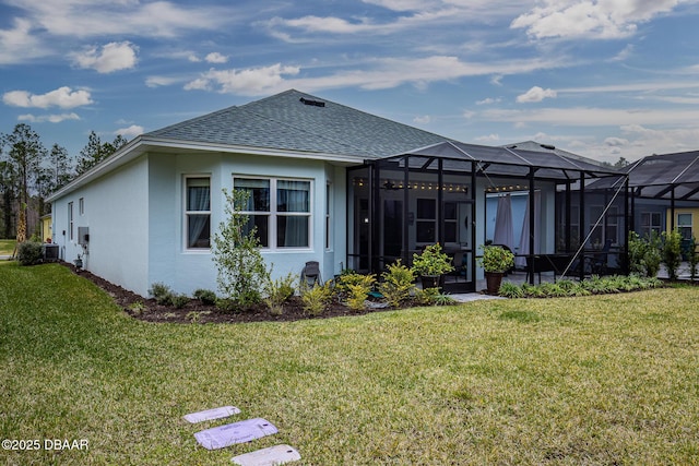 back of house featuring a lanai, a yard, and central AC