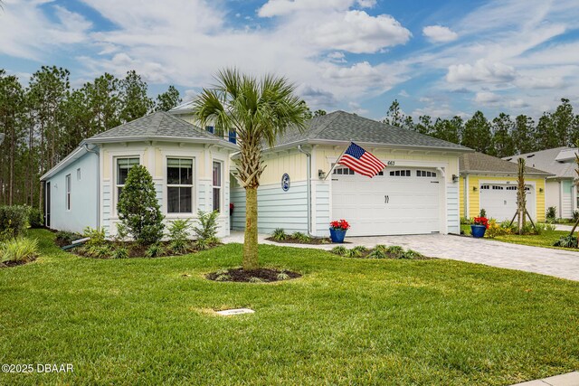 view of front of house featuring a garage and a front lawn