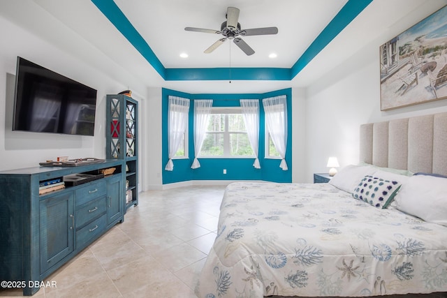 bedroom featuring ceiling fan and a tray ceiling