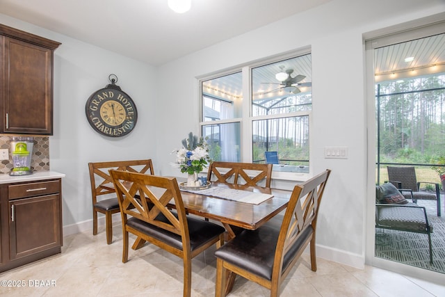 tiled dining room with ceiling fan and a healthy amount of sunlight