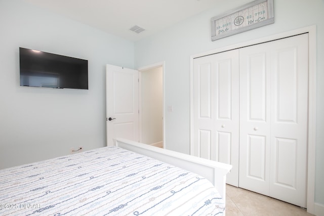 unfurnished bedroom featuring a closet and light tile patterned floors