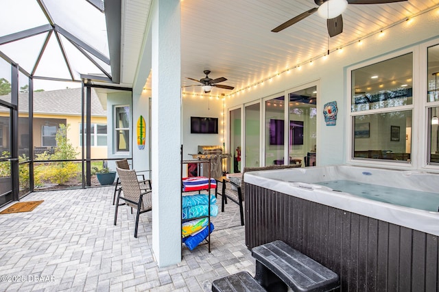 view of patio / terrace featuring a hot tub and ceiling fan