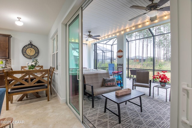 sunroom featuring ceiling fan