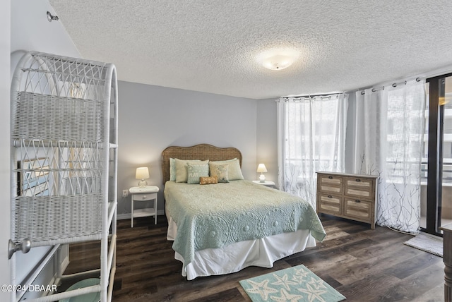3023 S Atlantic Ave Unit 5020, Daytona Beach Shores, FL 32118 - bedroom with a textured ceiling, wood finished floors, and baseboards