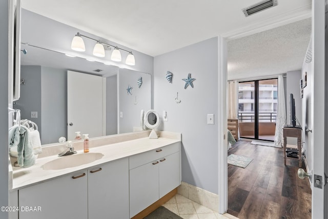 bathroom with vanity, hardwood / wood-style flooring, and a textured ceiling