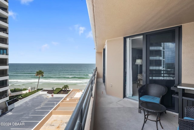 balcony with a view of the beach and a water view