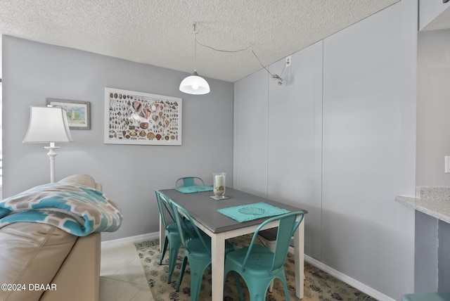 3023 S Atlantic Ave Unit 5020, Daytona Beach Shores, FL 32118 - dining area with a textured ceiling and baseboards