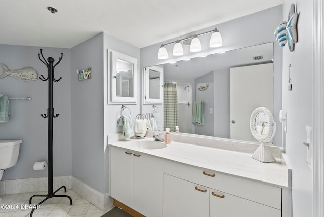 bathroom featuring toilet, a shower, vanity, and tile patterned flooring