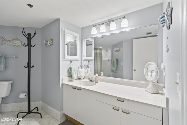 3023 S Atlantic Ave Unit 5020, Daytona Beach Shores, FL 32118 - full bath featuring toilet, baseboards, vanity, tile patterned floors, and curtained shower