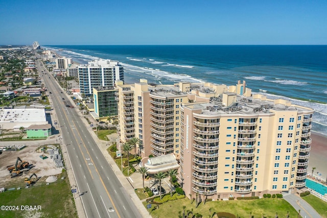 drone / aerial view with a water view and a beach view