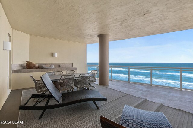 wooden terrace featuring a water view