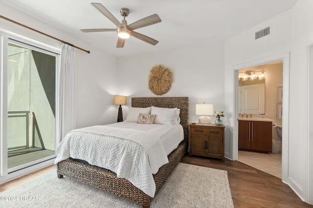 bedroom featuring access to exterior, ceiling fan, sink, dark hardwood / wood-style flooring, and ensuite bathroom