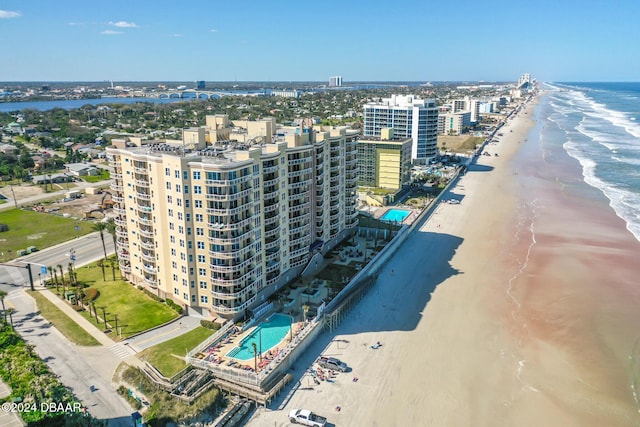 birds eye view of property with a water view and a view of the beach