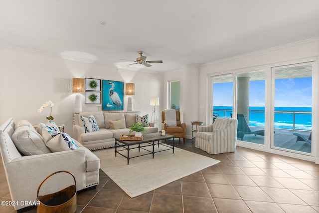 tiled living room with a water view, ceiling fan, and crown molding