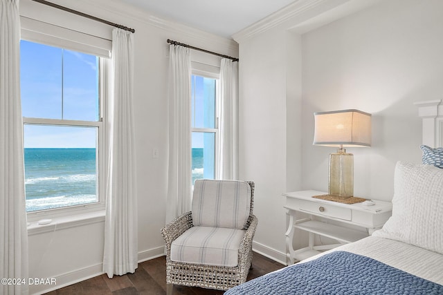 bedroom featuring crown molding, a water view, and dark hardwood / wood-style floors