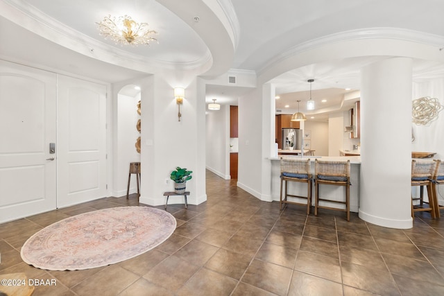 foyer featuring ornamental molding