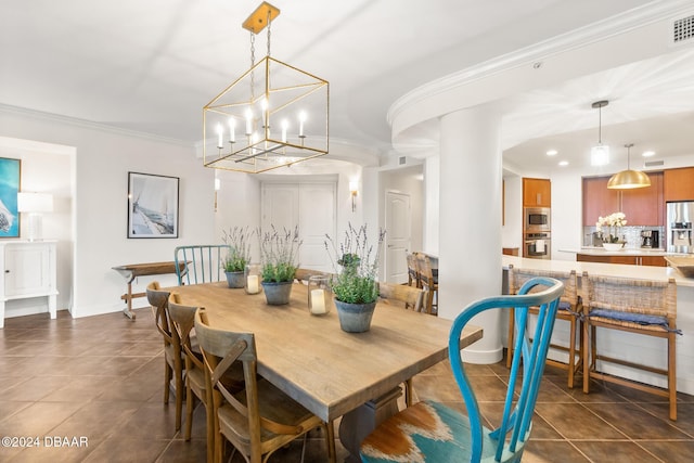 dining space with dark tile patterned flooring, ornamental molding, and a chandelier