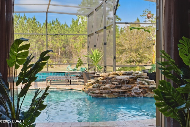 view of pool featuring a patio, a lanai, and pool water feature