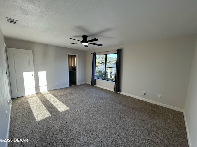 unfurnished bedroom featuring baseboards, visible vents, a ceiling fan, a textured ceiling, and carpet flooring