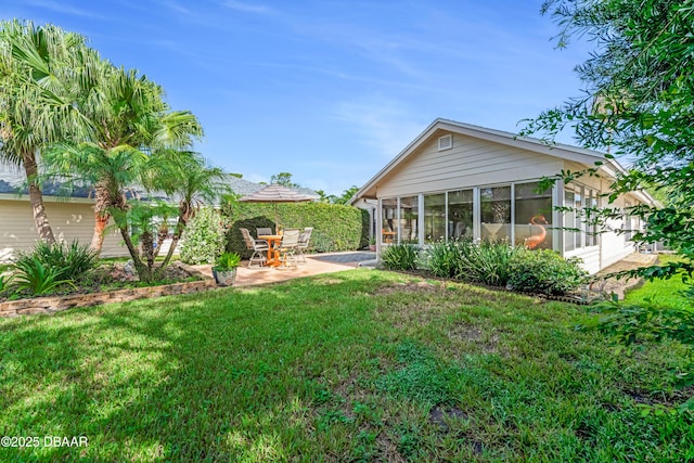 916 Ashmeade Ct, Port Orange, FL 32127 - rear view of property featuring a sunroom, a patio area, and a yard