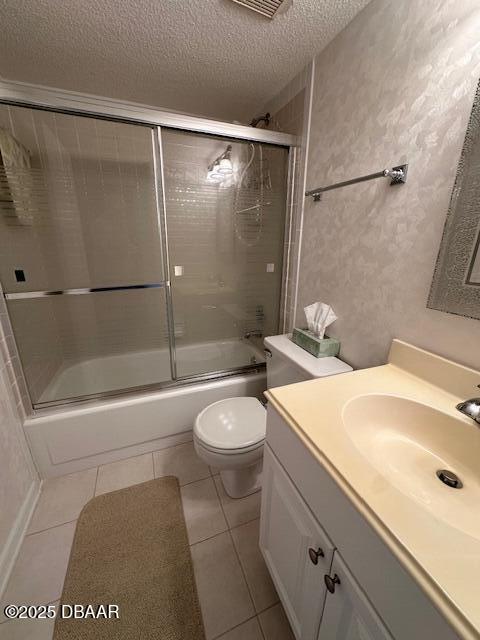 full bathroom with vanity, combined bath / shower with glass door, and toilet