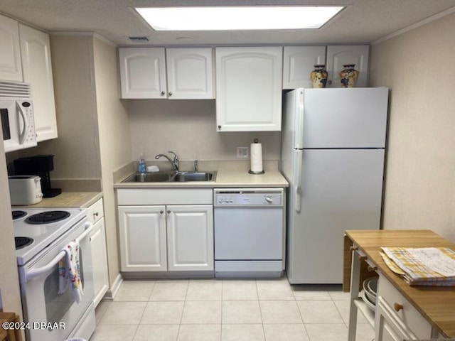 2700 Ocean Shore Blvd Unit 402, Ormond Beach, FL 32176 - kitchen with white appliances, a sink, white cabinetry, light tile patterned floors, and a textured ceiling