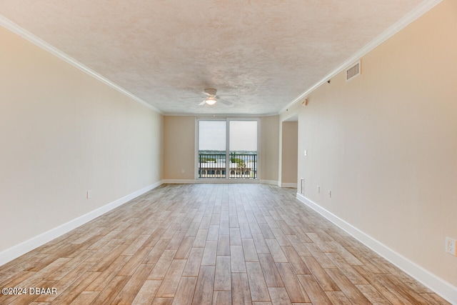 empty room featuring ceiling fan, a textured ceiling, ornamental molding, and light hardwood / wood-style flooring