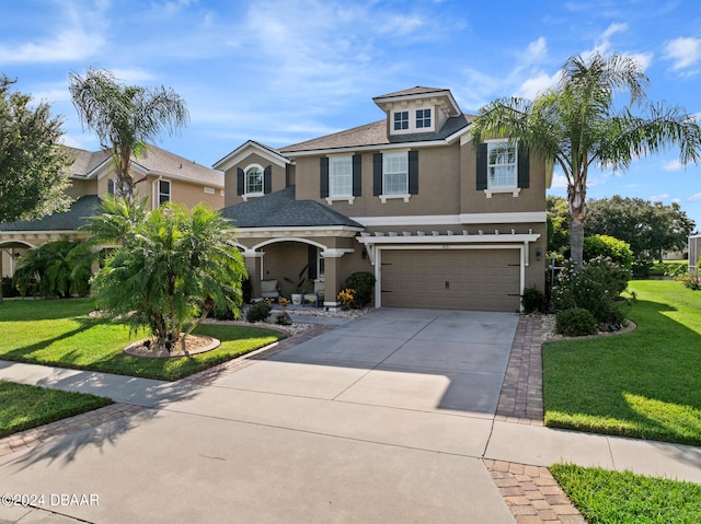 view of front of house with a garage and a front yard