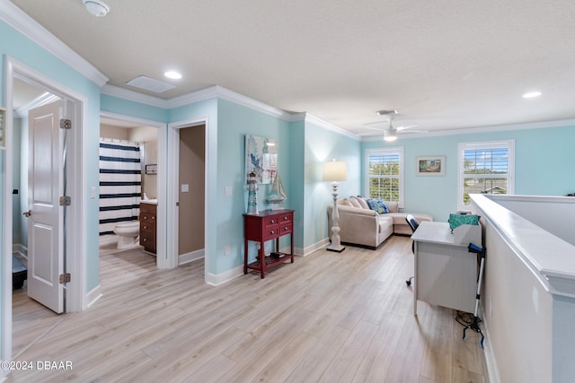 interior space with a textured ceiling, light hardwood / wood-style flooring, ceiling fan, and crown molding