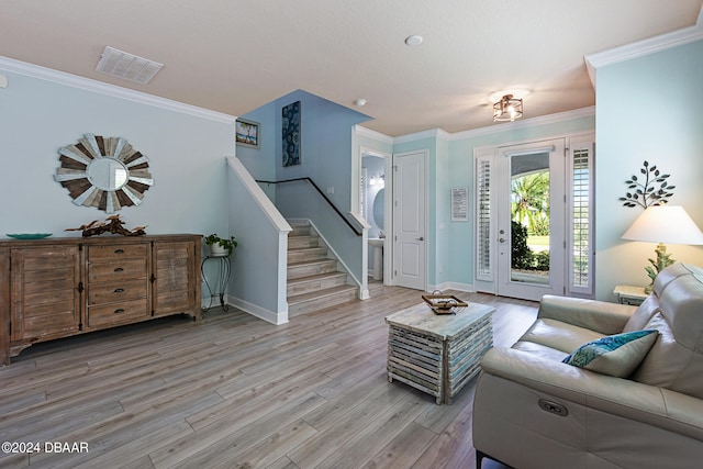 living room featuring light wood-type flooring and crown molding