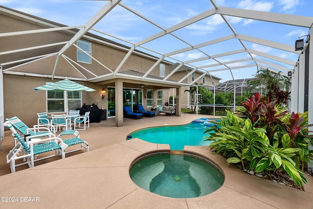 view of pool with a patio, glass enclosure, an in ground hot tub, and an outdoor living space