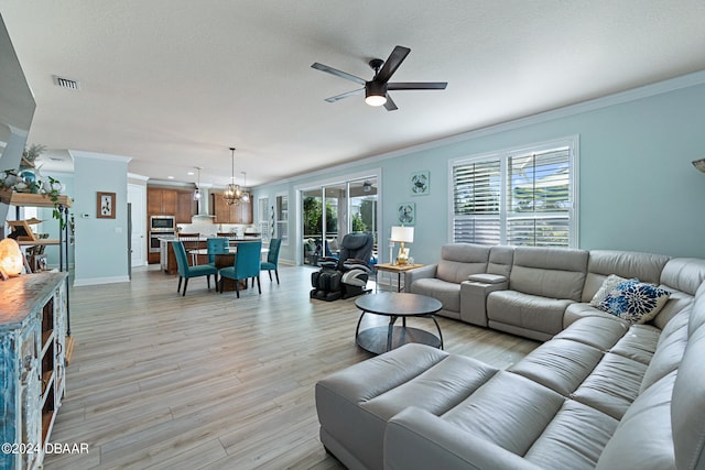 living room with a textured ceiling, ceiling fan with notable chandelier, crown molding, and light hardwood / wood-style flooring