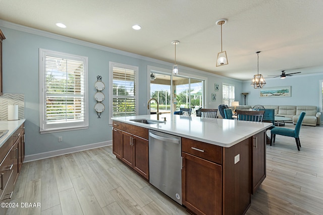 kitchen with light hardwood / wood-style floors, sink, stainless steel dishwasher, hanging light fixtures, and an island with sink