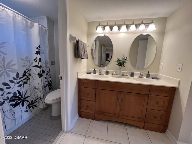 bathroom featuring toilet, vanity, and tile patterned flooring