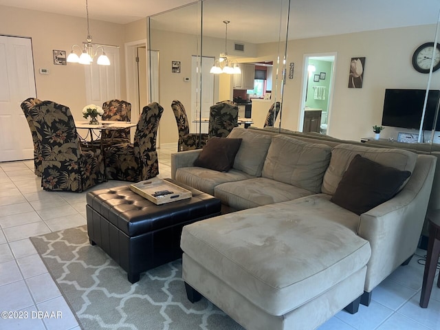 tiled living room featuring an inviting chandelier