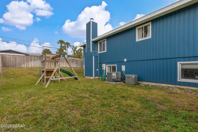 view of yard featuring central air condition unit and a playground