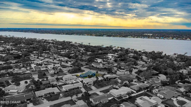 aerial view at dusk with a water view