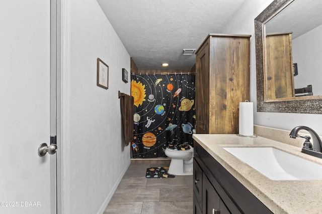 bathroom featuring a textured ceiling, tile patterned flooring, a shower with curtain, toilet, and vanity