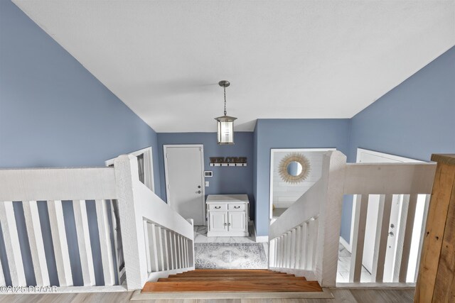 staircase with hardwood / wood-style floors