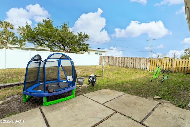 view of yard featuring a patio area and a trampoline